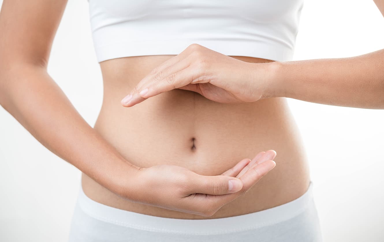 Woman with hands around stomach area